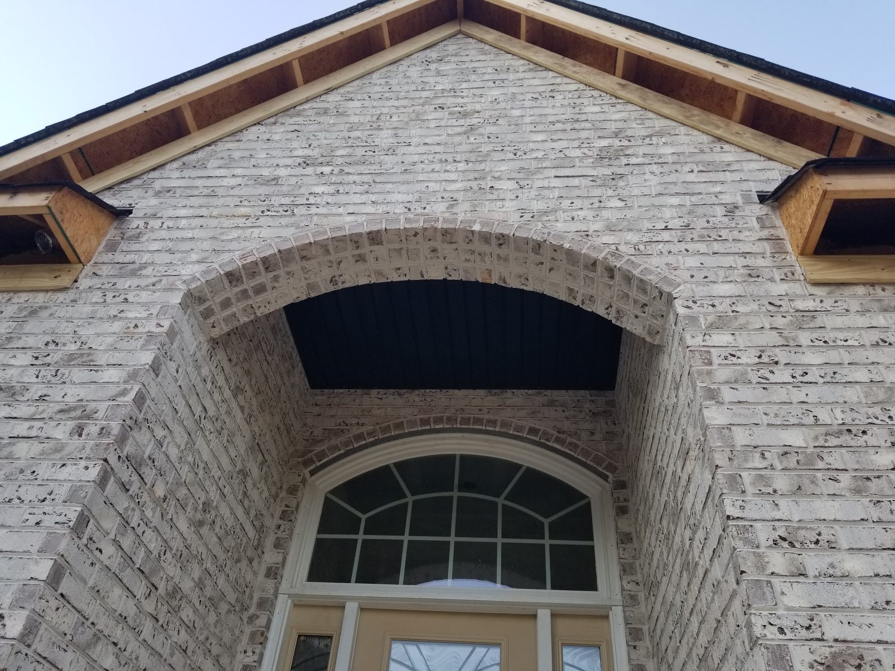 Arched brick entry detail on a custom home built by Tessco Construction