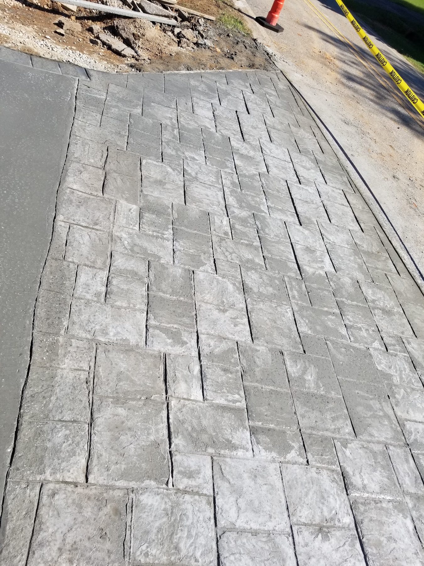 Stamped concrete with a slate pattern finish poured by Tessco Construction