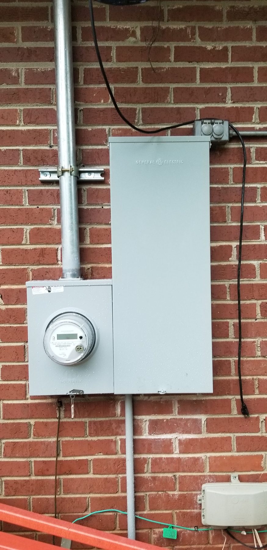 Finished electrical service panel and meter on a brick home