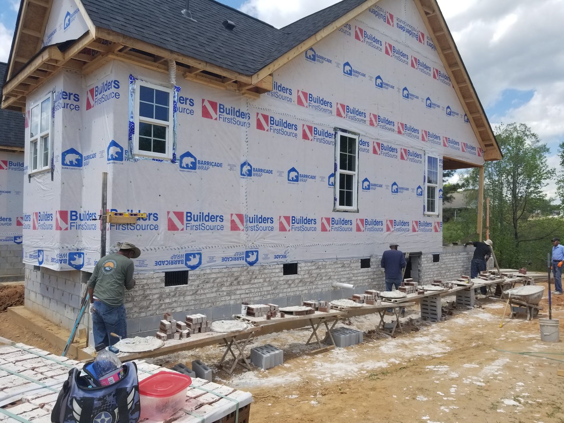 Tessco Construction crew laying block and framing a new home foundation