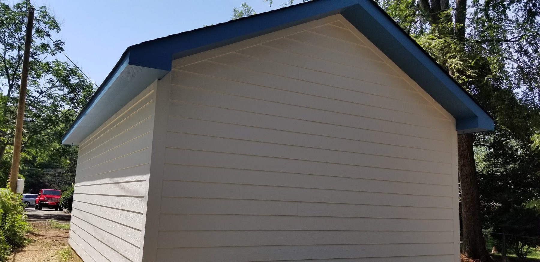 Finished detached garage with a blue metal roof built by Tessco Construction