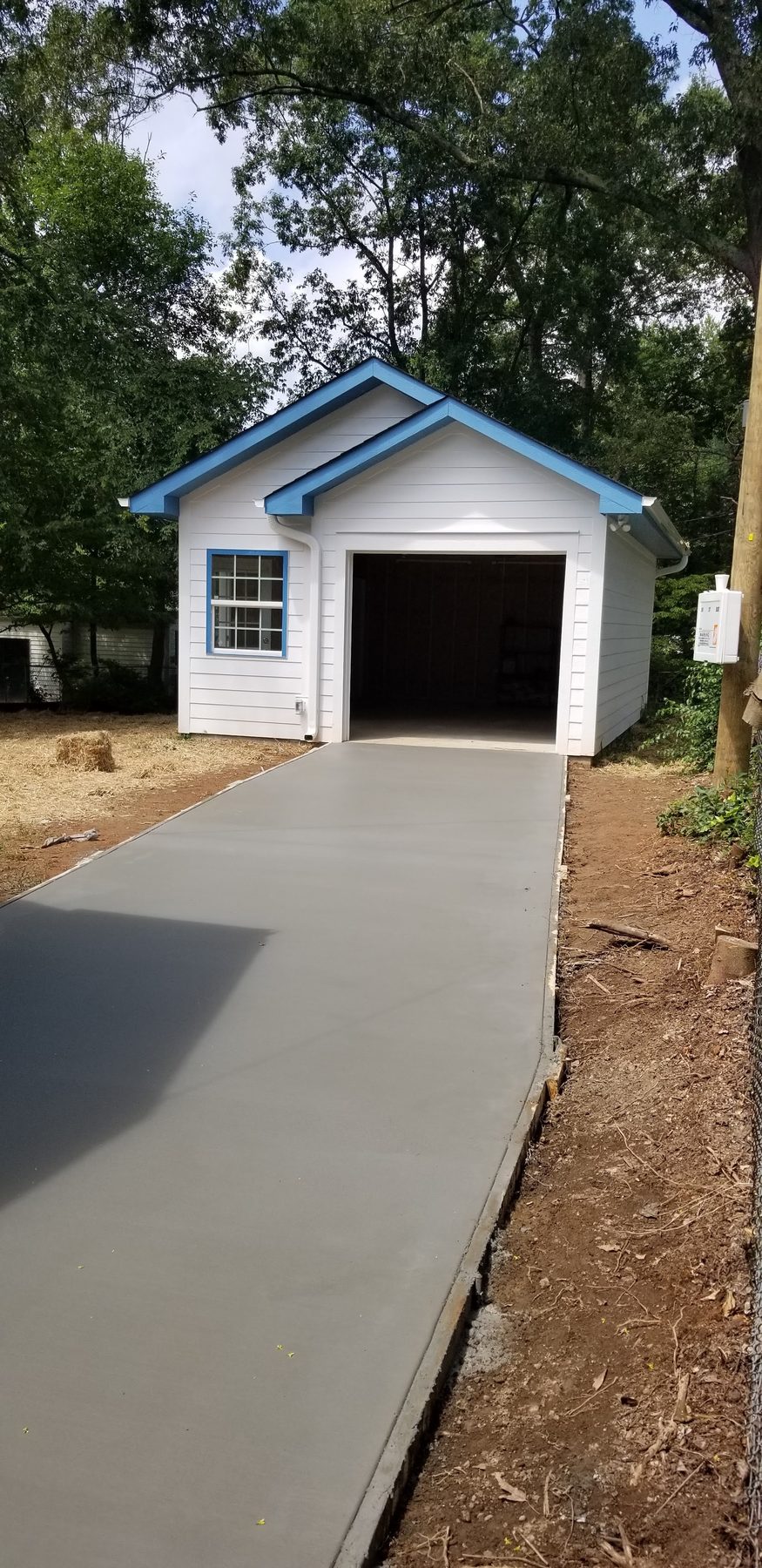 Detached garage built by Tessco Construction with a new concrete apron